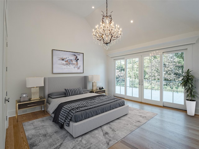 bedroom featuring wood finished floors, multiple windows, and access to exterior