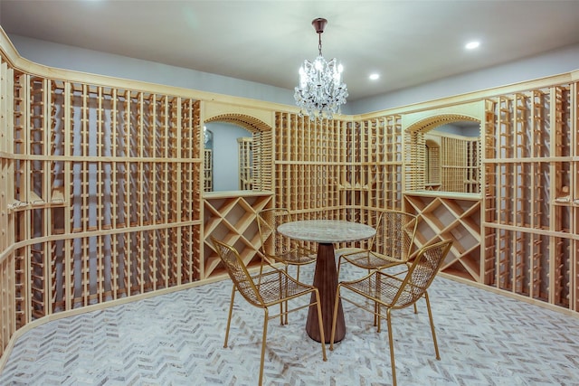 wine room with recessed lighting and an inviting chandelier