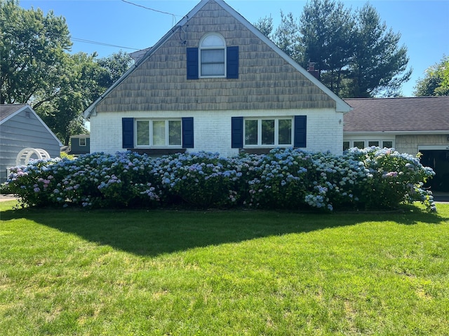 view of front of house with brick siding and a front lawn