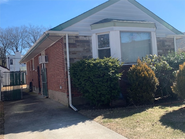 view of property exterior featuring brick siding and stone siding