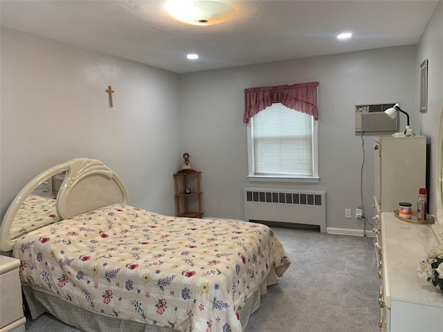 bedroom featuring recessed lighting, light colored carpet, radiator heating unit, and a wall mounted AC