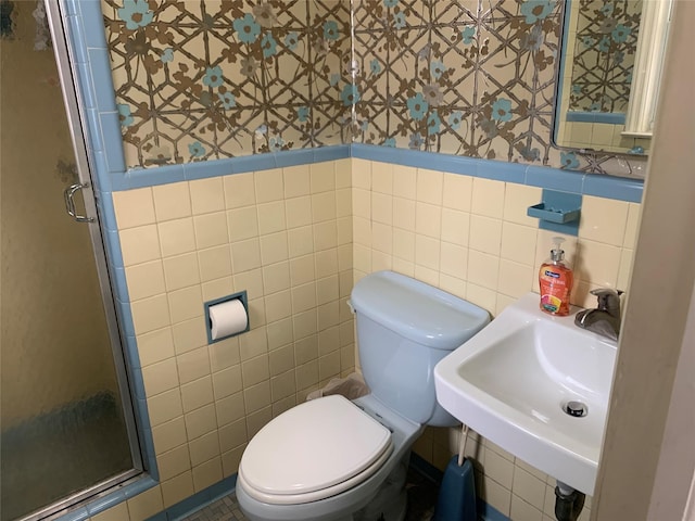 bathroom with a shower stall, wallpapered walls, and toilet