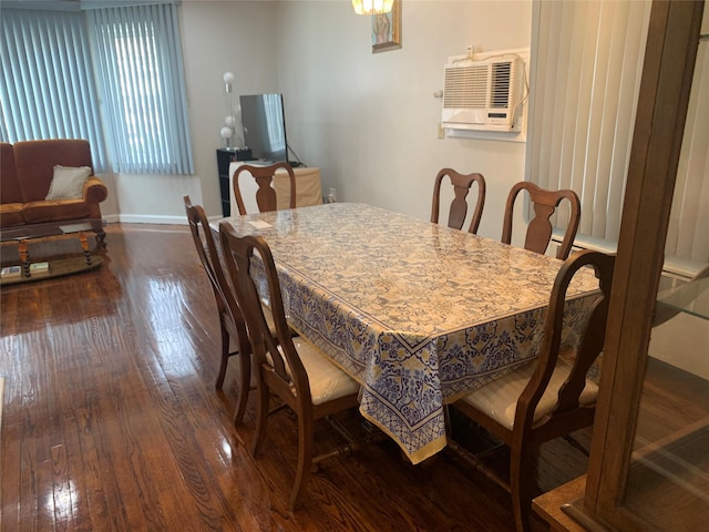 dining space with baseboards, a wall mounted AC, and hardwood / wood-style flooring