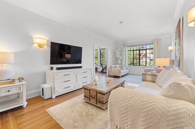 living room featuring crown molding, wood finished floors, and baseboards