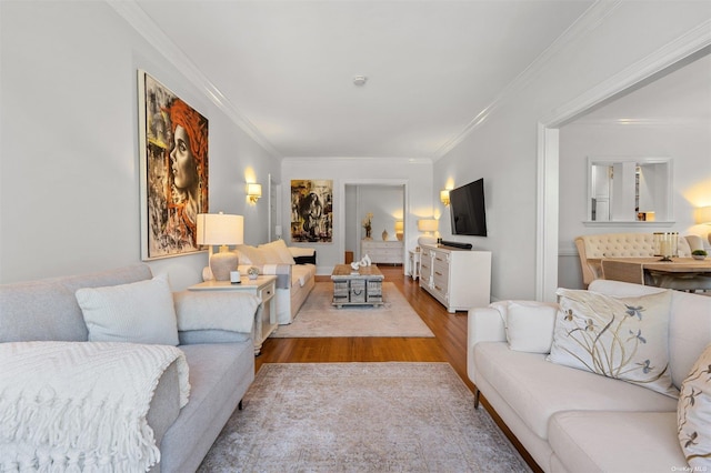 living room with wood finished floors and crown molding