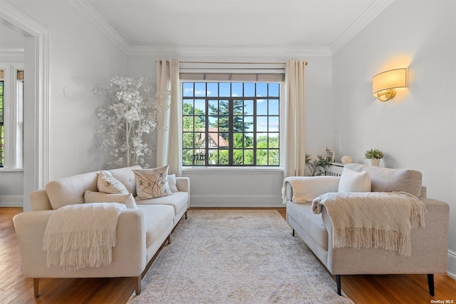 interior space with baseboards, wood finished floors, and crown molding