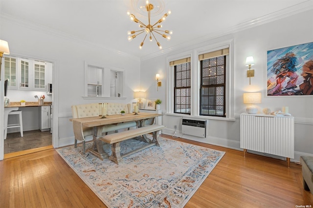 dining area featuring heating unit, light wood-style flooring, radiator, and ornamental molding