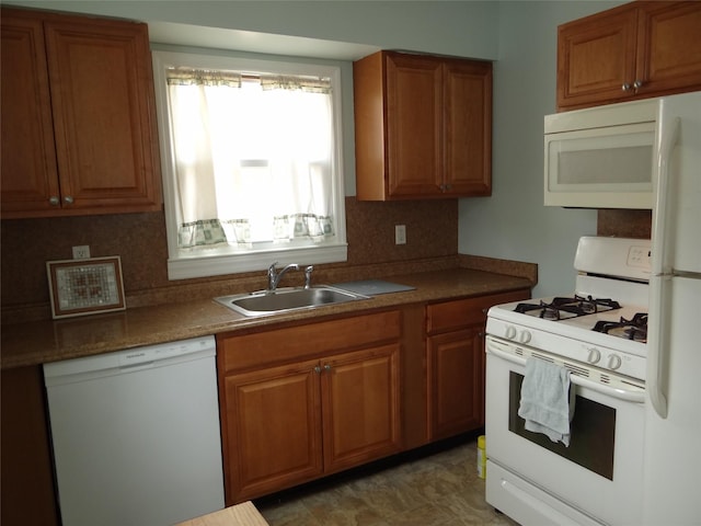 kitchen with a sink, white appliances, tasteful backsplash, and brown cabinets