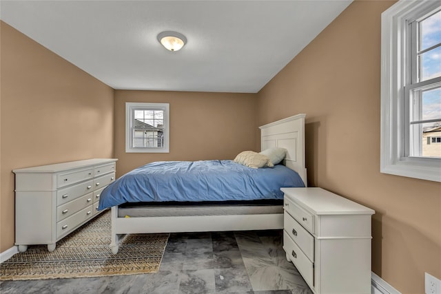 bedroom featuring marble finish floor