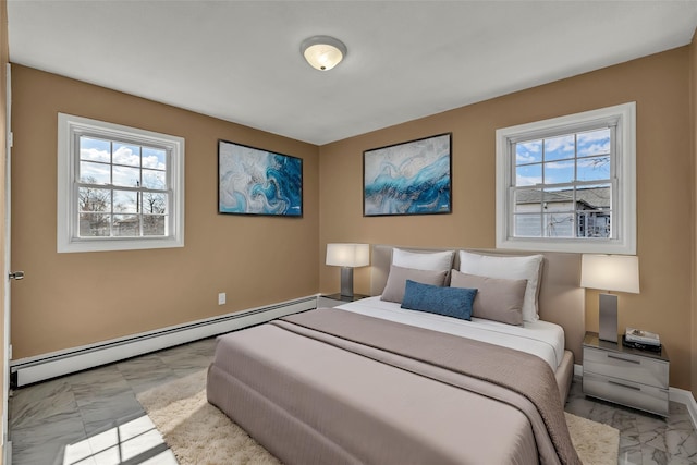 bedroom with baseboards, marble finish floor, and a baseboard radiator