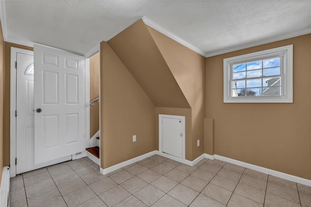 additional living space with baseboards, stairs, vaulted ceiling, light tile patterned floors, and a textured ceiling