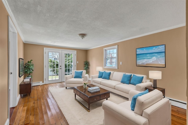 living area with french doors, baseboard heating, crown molding, and light wood finished floors