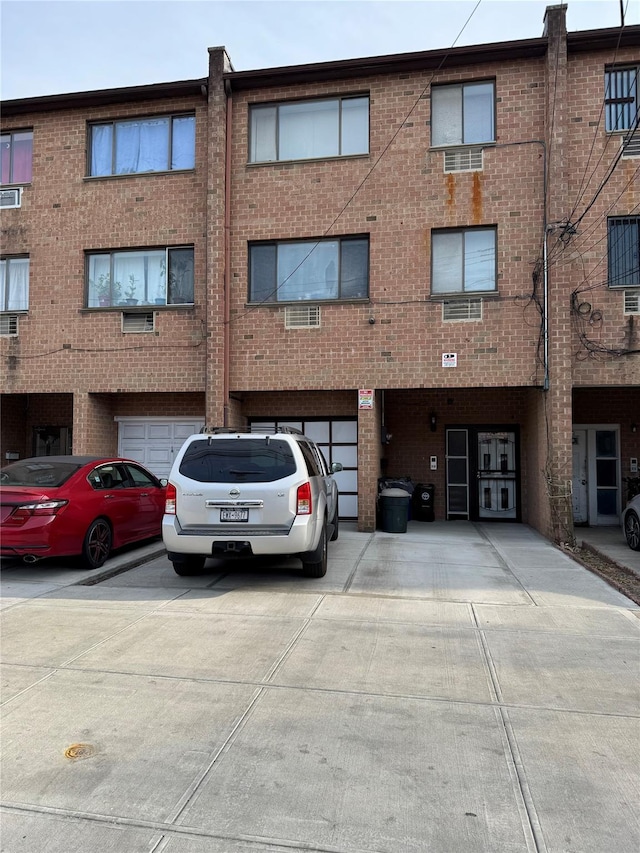 view of building exterior with driveway and a garage