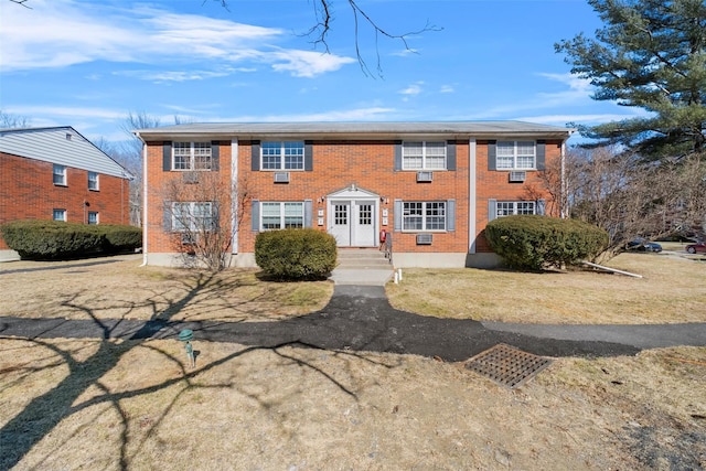 colonial house featuring brick siding