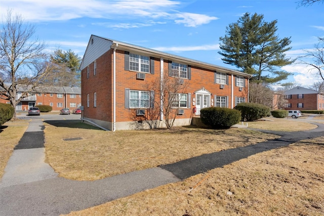 colonial-style house with brick siding