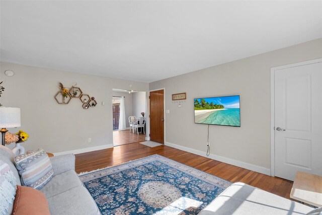 living area featuring baseboards and wood finished floors