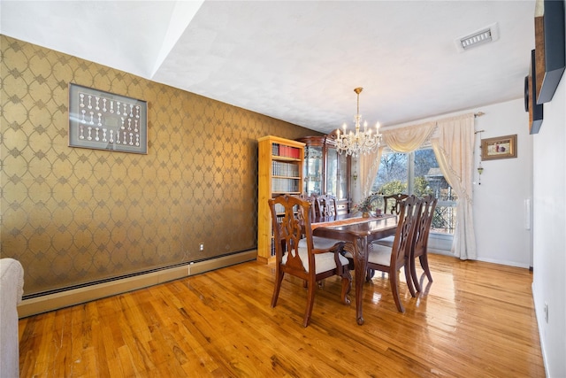 dining room featuring visible vents, wood finished floors, wallpapered walls, a baseboard radiator, and a chandelier