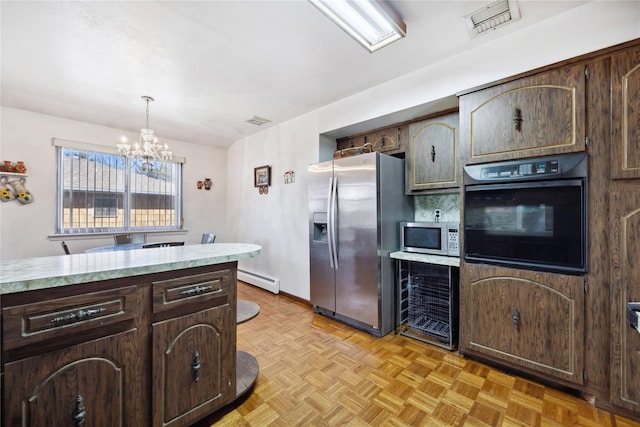 kitchen with visible vents, dark brown cabinetry, appliances with stainless steel finishes, light countertops, and a baseboard radiator