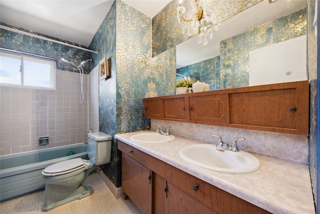 bathroom featuring washtub / shower combination, wallpapered walls, toilet, and a sink