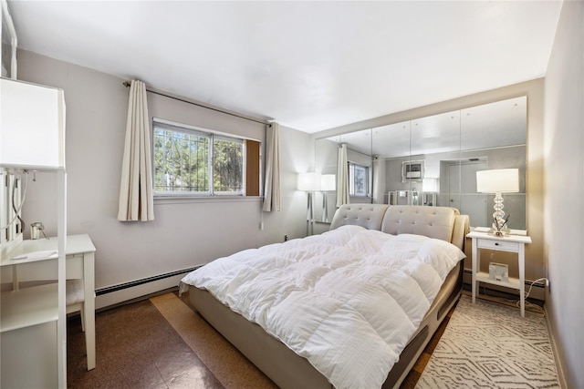 bedroom featuring a baseboard radiator, baseboard heating, and a wall mounted AC