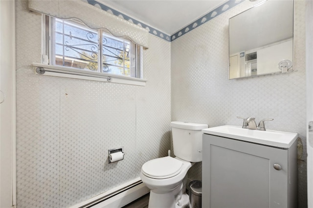 bathroom featuring wallpapered walls, toilet, vanity, and a baseboard radiator