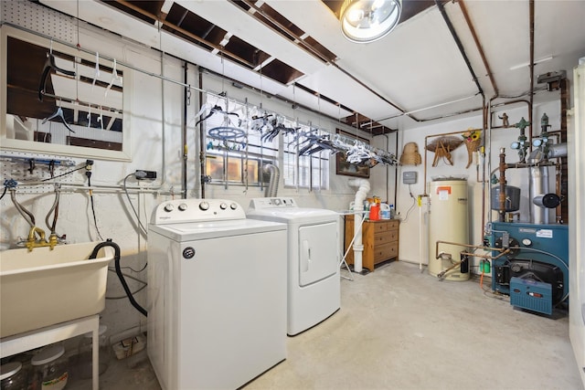 washroom with a sink, gas water heater, separate washer and dryer, a heating unit, and laundry area