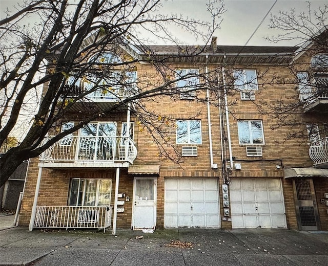 multi unit property with aphalt driveway and brick siding