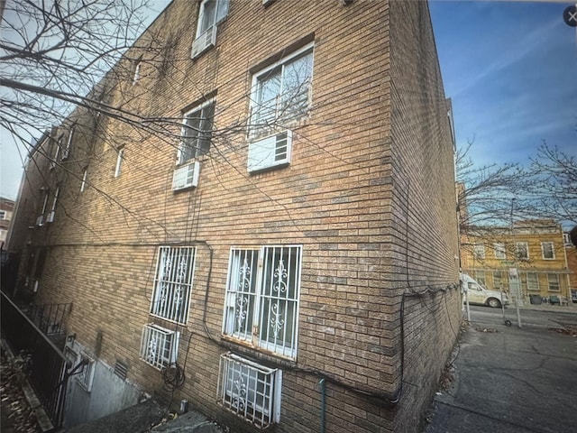 view of side of property with brick siding