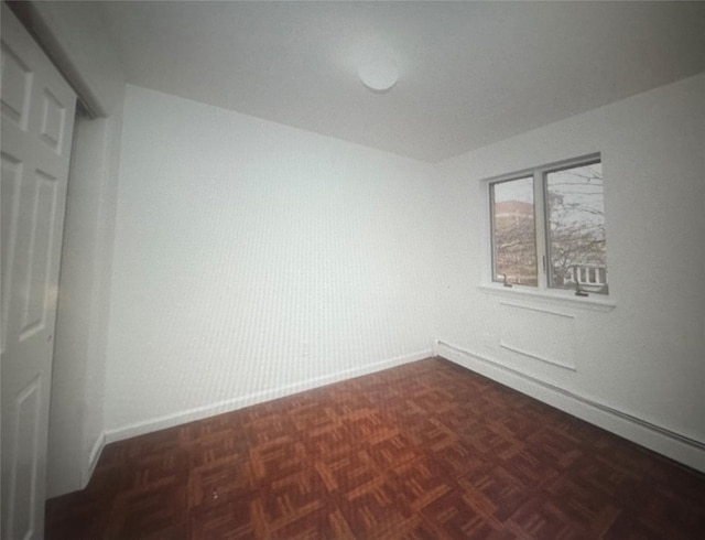 unfurnished room with baseboards