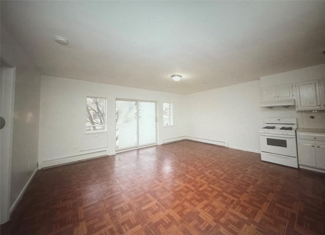 unfurnished living room featuring baseboards and a baseboard radiator