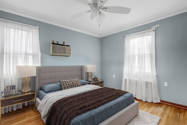 bedroom with ornamental molding, ceiling fan, and wood finished floors