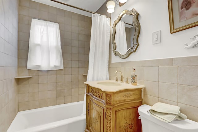 full bath with vanity, tile walls, toilet, and shower / tub combo with curtain