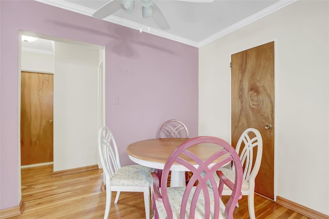 dining room with crown molding, light wood-type flooring, and ceiling fan