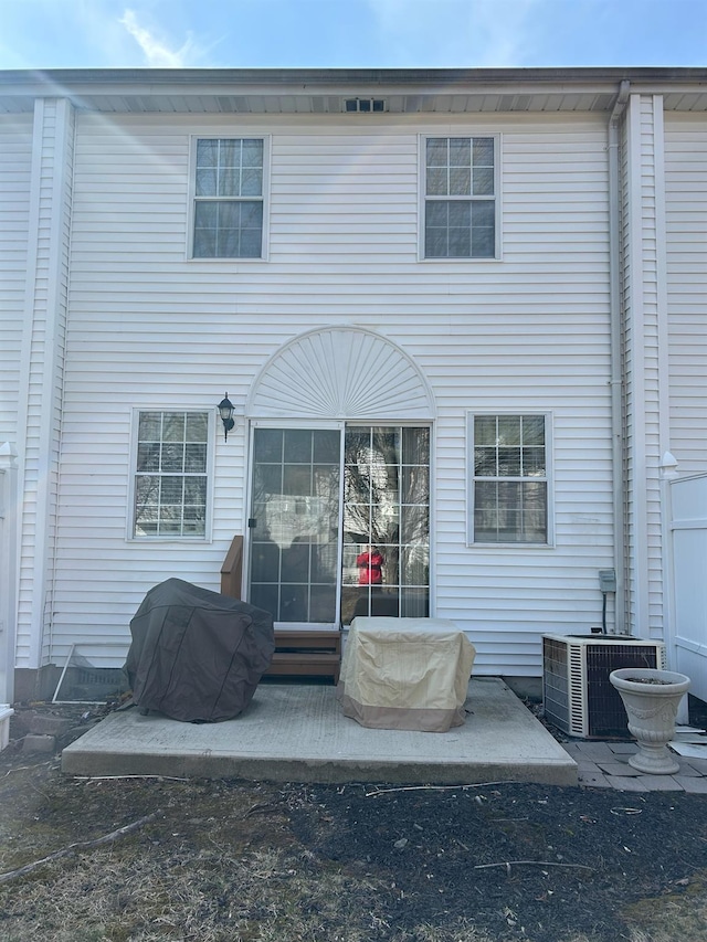 back of property with central AC and entry steps