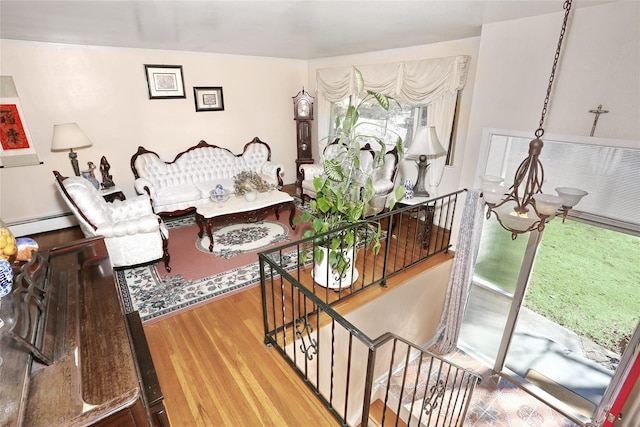 interior space featuring a baseboard heating unit and wood finished floors