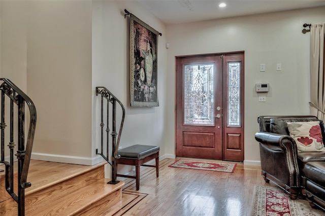 foyer entrance featuring recessed lighting, wood finished floors, and baseboards