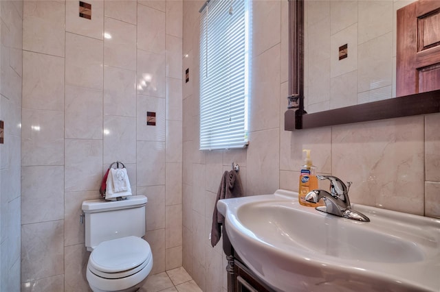 bathroom featuring tile patterned floors, toilet, tile walls, and vanity