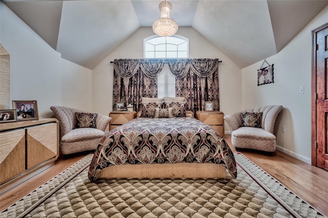 bedroom featuring baseboards, lofted ceiling, and light wood-style floors