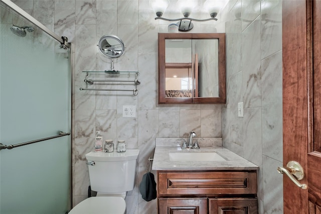 bathroom featuring vanity, tile walls, toilet, and walk in shower