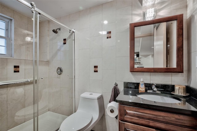 full bathroom featuring vanity, tile walls, toilet, and a stall shower