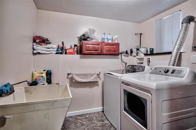 laundry room featuring laundry area, washing machine and dryer, baseboards, and a sink