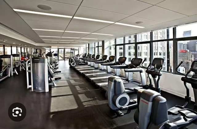 30 W 63rd St Unit 8T, New York Manhattan, NY 10023 - workout area featuring a drop ceiling and baseboards