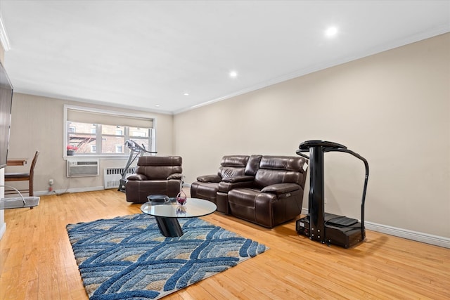 living room featuring ornamental molding, wood finished floors, radiator heating unit, recessed lighting, and baseboards