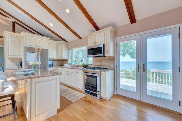 48 Crows Nest Dr, Baiting Hollow, NY 11901 - kitchen with stainless steel appliances, french doors, backsplash, light stone countertops, and recessed lighting