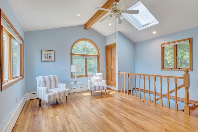 48 Crows Nest Dr, Baiting Hollow, NY 11901 - living area featuring wood finished floors, a skylight, ceiling fan, an upstairs landing, and baseboard heating
