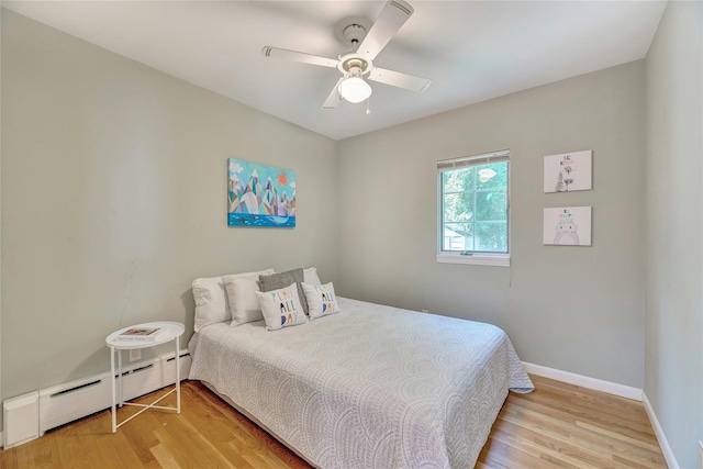 48 Crows Nest Dr, Baiting Hollow, NY 11901 - bedroom with baseboard heating, light wood-style flooring, baseboards, and ceiling fan
