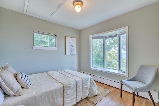 48 Crows Nest Dr, Baiting Hollow, NY 11901 - bedroom with wood finished floors and baseboard heating