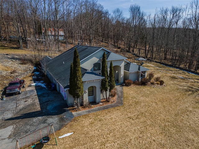 drone / aerial view featuring a wooded view