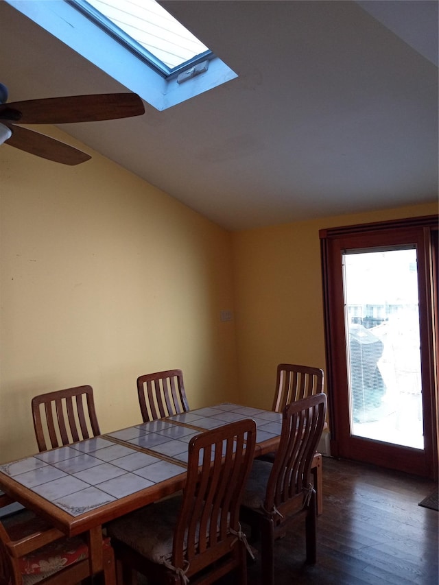 dining room with lofted ceiling, wood finished floors, and ceiling fan