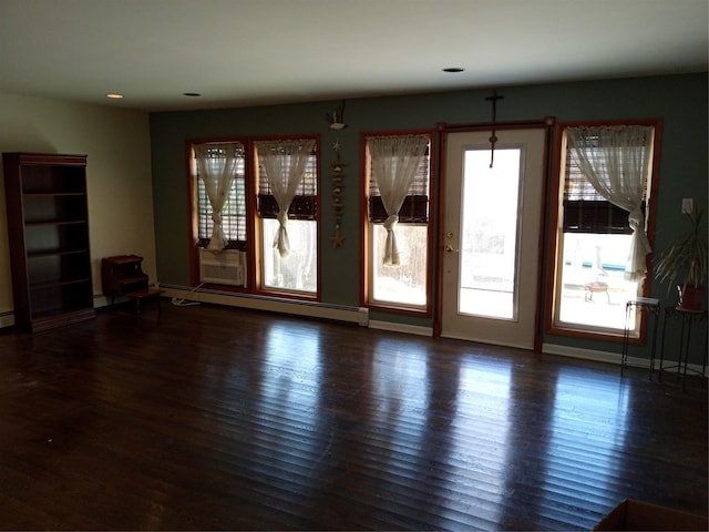 unfurnished living room with recessed lighting, baseboards, baseboard heating, and wood finished floors